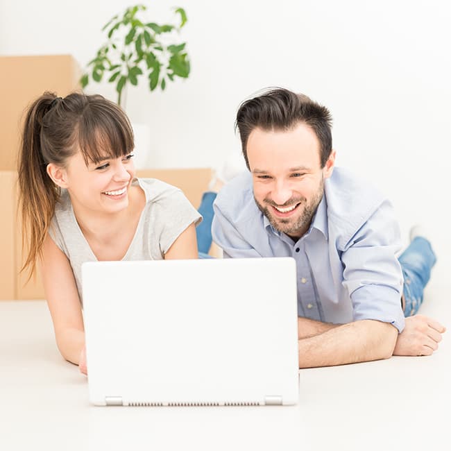 Young couple on floor with laptop